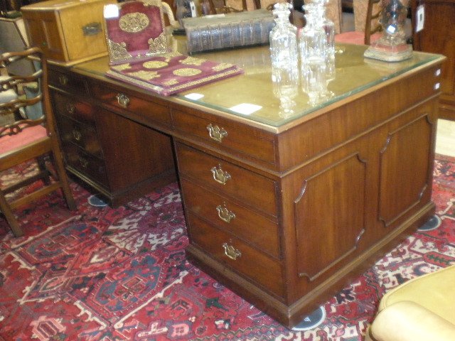 A THREE PIECE EXECUTIVE'S OFFICE SUITE, BY KITTING: A THREE PIECE EXECUTIVE'S OFFICE SUITE, BY KITTINGER, BUFFALO, NEW YORK, LATE 20TH CENTURY, the large George III style carved mahogany pedestal desk with a rectangular top centering an inset tooled le