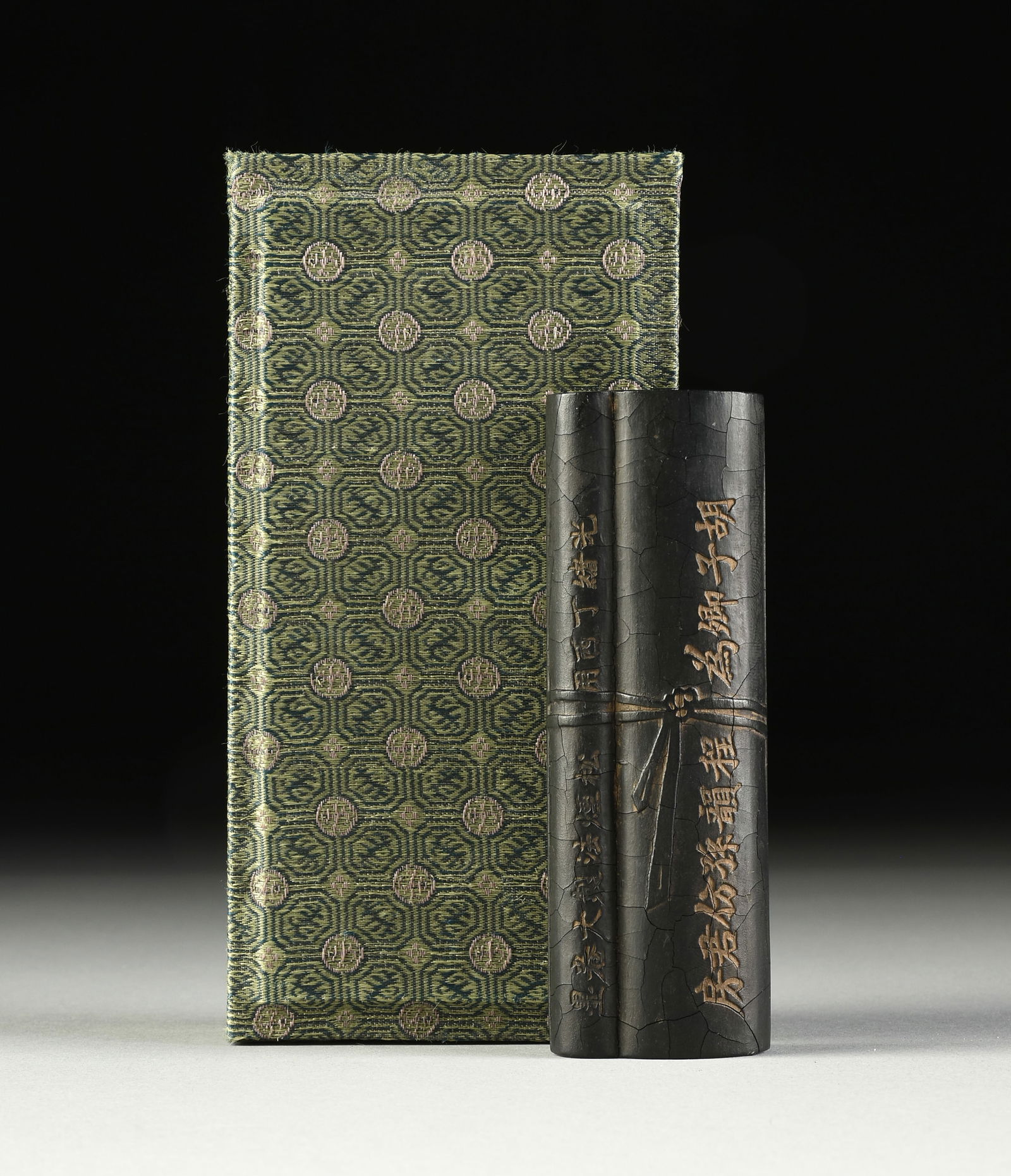 A CHINESE INK STICK, IN THE FORM OF A ROLLED SCROLL, QING DYNASTY (1644-1912), MID/LATE 19TH CENTURY (1 of 6)