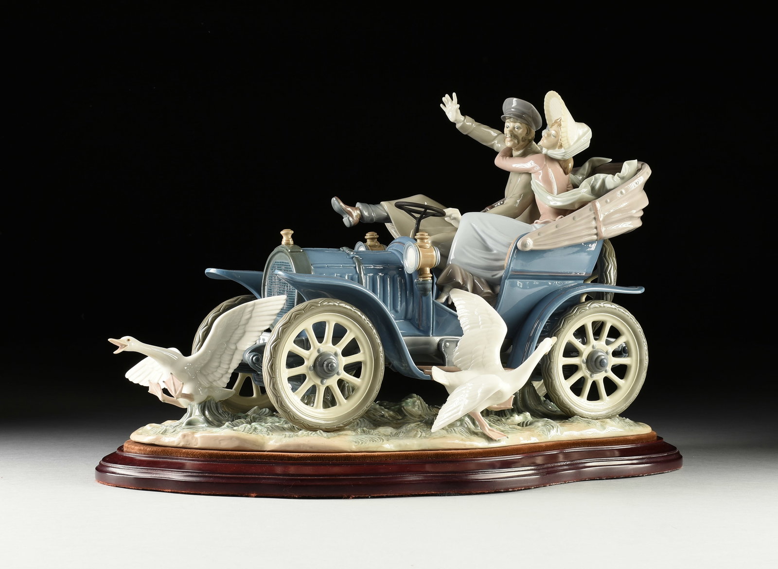 A LLADRÓ PORCELAIN FIGURAL GROUP, "Car in Trouble," 1978-1987: A LLADRÓ PORCELAIN FIGURAL GROUP, "Car in Trouble," 1978-1987, model #1375, with blue Lladró stamp at base and the signatures of the sculptor, "J. Debon," and the painter, "J. Ruiz," numbered, "No 3