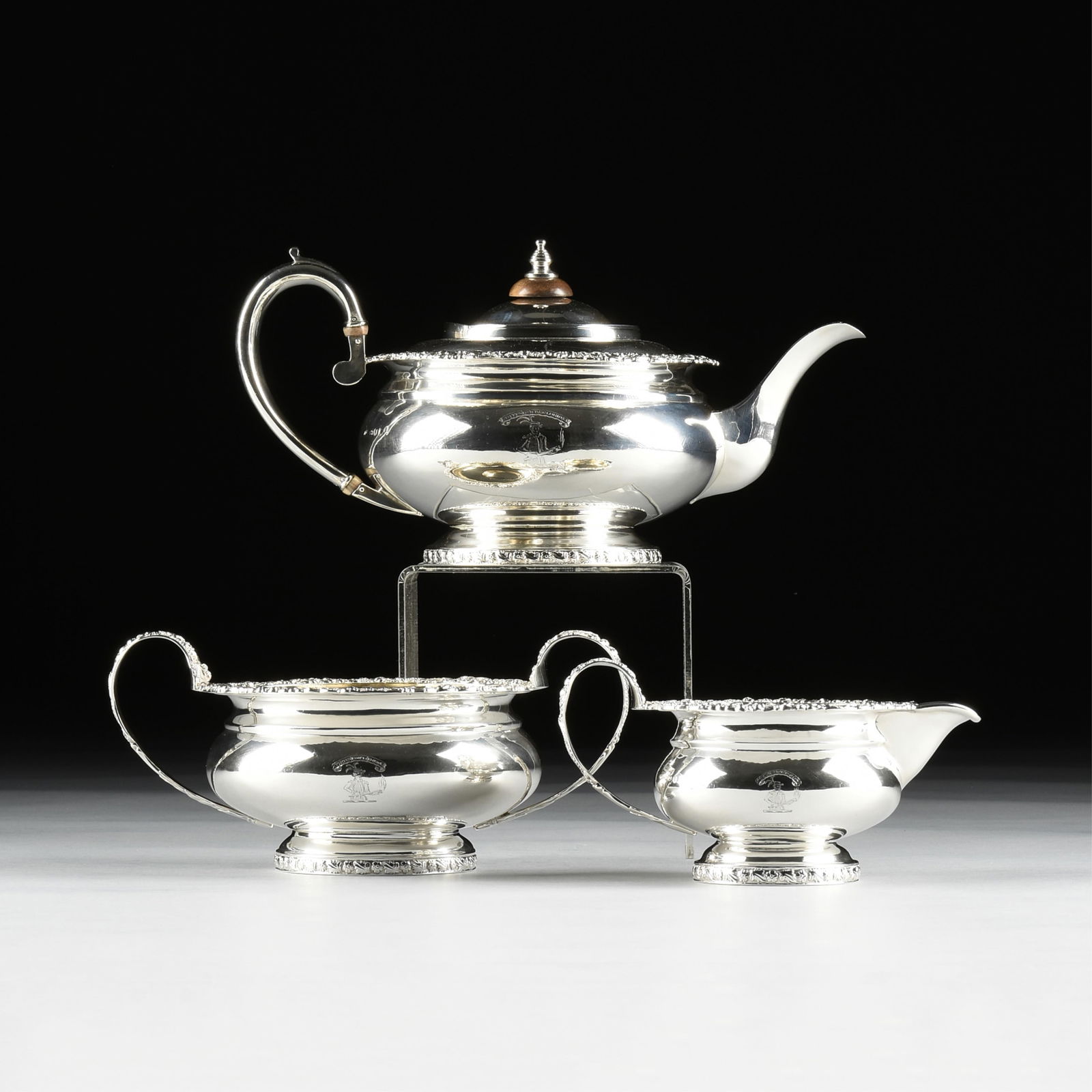 A GEORGE II THREE PIECE STERLING SILVER TEA SET, MARK OF MICHAEL STARKEY, ARMORIAL CREST AND MOTTO (1 of 17)