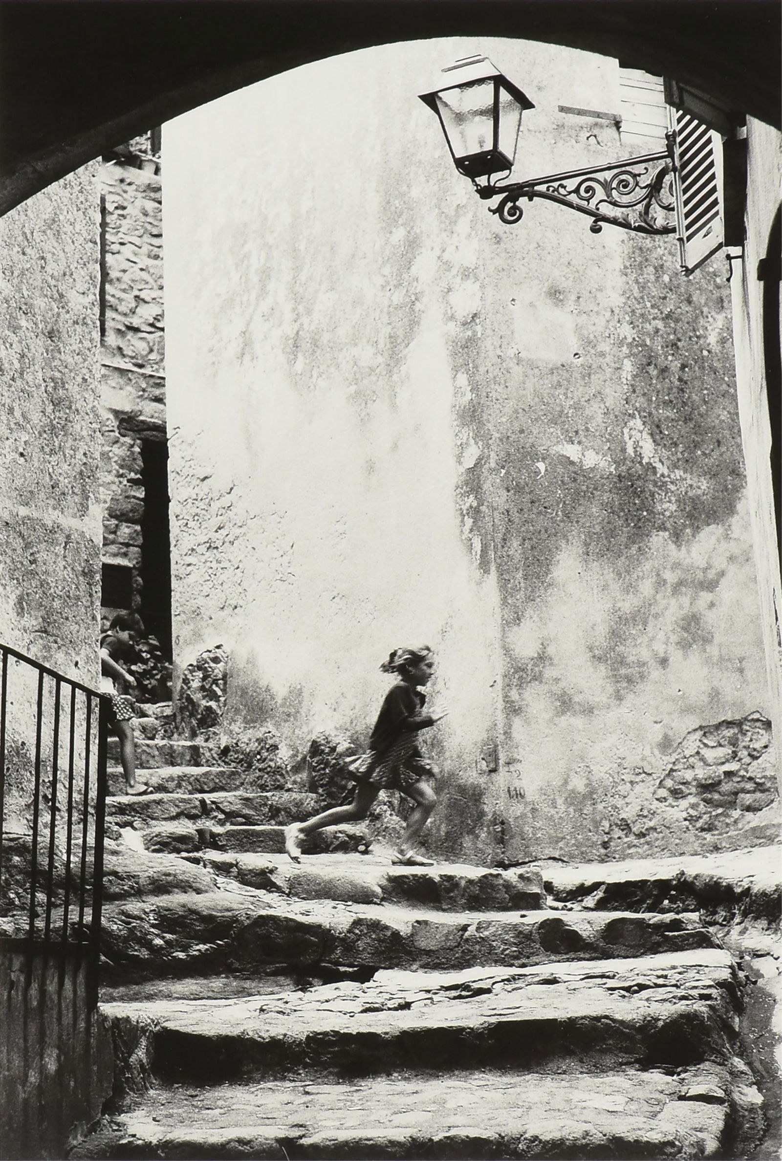 RICHARD KHANLIAN (American 1939-2019) A PHOTOGRAPH, "Girl Running on Steps," 1966 (1 of 10)
