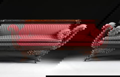 AN EMPIRE STYLE SOFA, AMERICAN, 19TH CENTURY,: AN EMPIRE STYLE SOFA, AMERICAN, 19TH CENTURY, carved mahogany sofa with claw feet on casters, red striped upholstery, and two bolster pillows. 36 x 88 x 27 in. (91.4 x 223.5 x 68.6 cm.) Provenance: Co