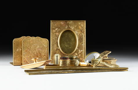 A TIFFANY STUDIOS FIFTEEN PIECE "Grapevine" DESK SET, AMERICAN, EARLY 20TH CENTURY,: A TIFFANY STUDIOS FIFTEEN PIECE "Grapevine" DESK SET, AMERICAN, EARLY 20TH CENTURY, a gilt bronze and glass desk set ornamented with a stylized pattern of grapes and vines, including a picture frame (