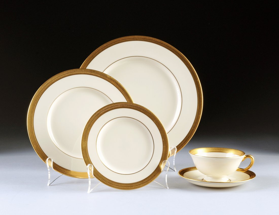 A FORTY-EIGHT PIECE LENOX PARCEL GILT IVORY GROUND: A FORTY-EIGHT PIECE LENOX PARCEL GILT IVORY GROUND DINNERWARE SERVICE, LOWELL PATTERN, in traditional pattern and with overglaze maker's gilt marks on underside, comprising twelve dinner plates, twelv