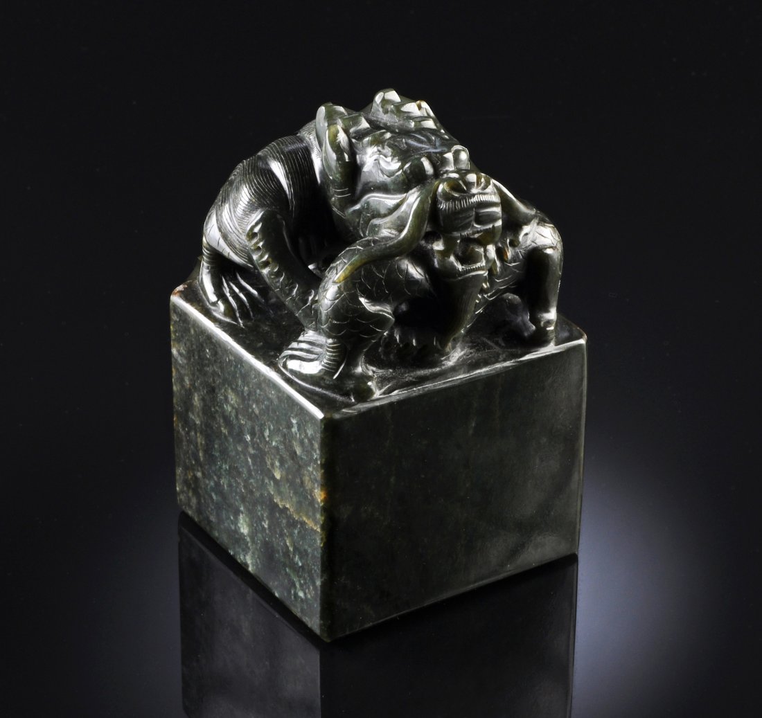 A LARGE IMPERIAL SPINACH GREEN JADE DRAGON SEAL, Q: A LARGE IMPERIAL SPINACH GREEN JADE DRAGON SEAL, QING DYNASTY, 19TH CENTURY, the large square seal with single dragon curled upon himself, the base carved in zhuwen, positive text, with two columns in