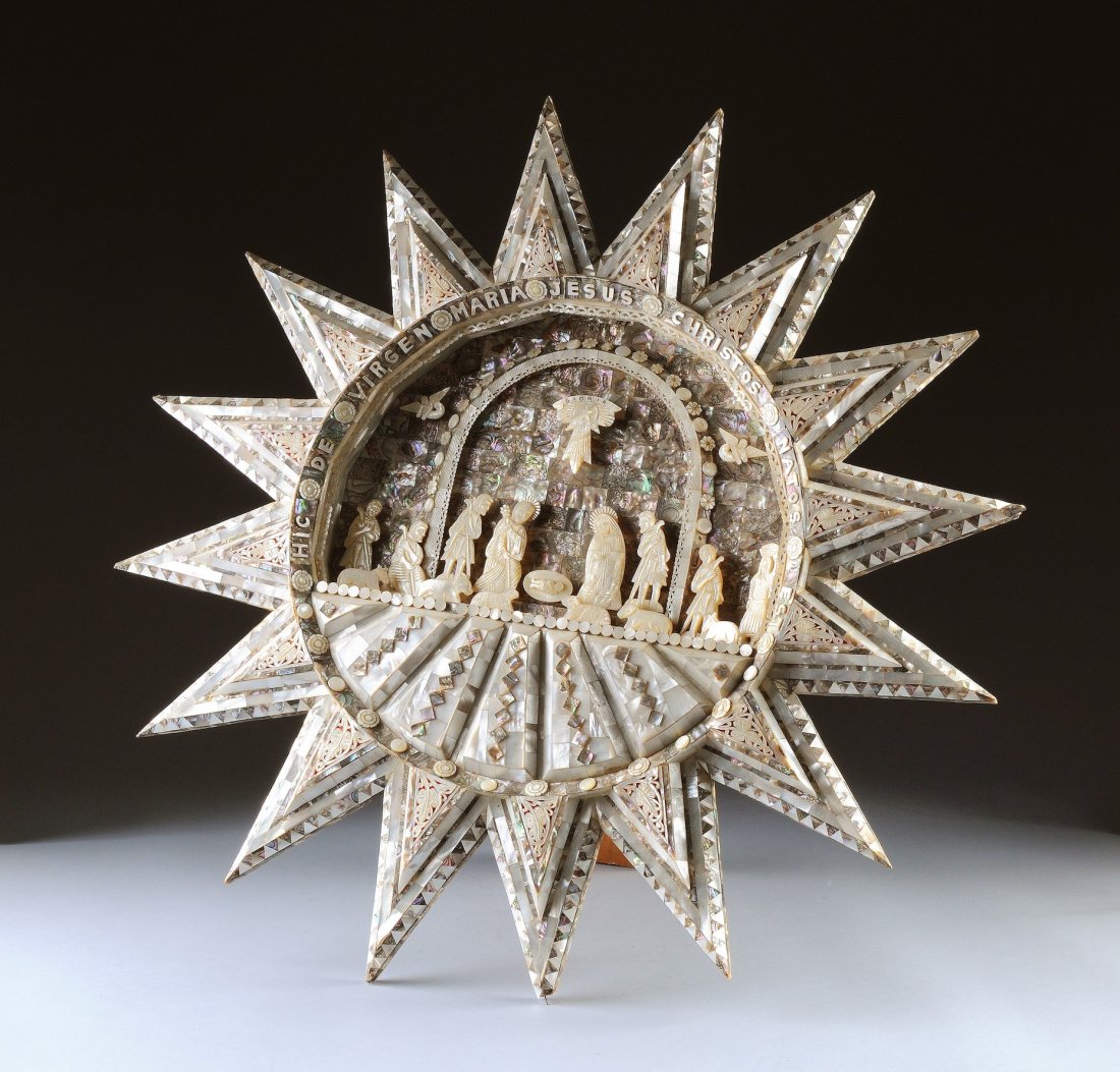 A MOTHER-OF-PEARL NATIVITY SCENE, POSSIBLY LATIN-: A MOTHER-OF-PEARL NATIVITY SCENE, POSSIBLY LATIN-AMERICAN, 20TH CENTURY, of circular radiating star form and elaborately detailed centering a staged set depicting the Nativity with flat cut figures an