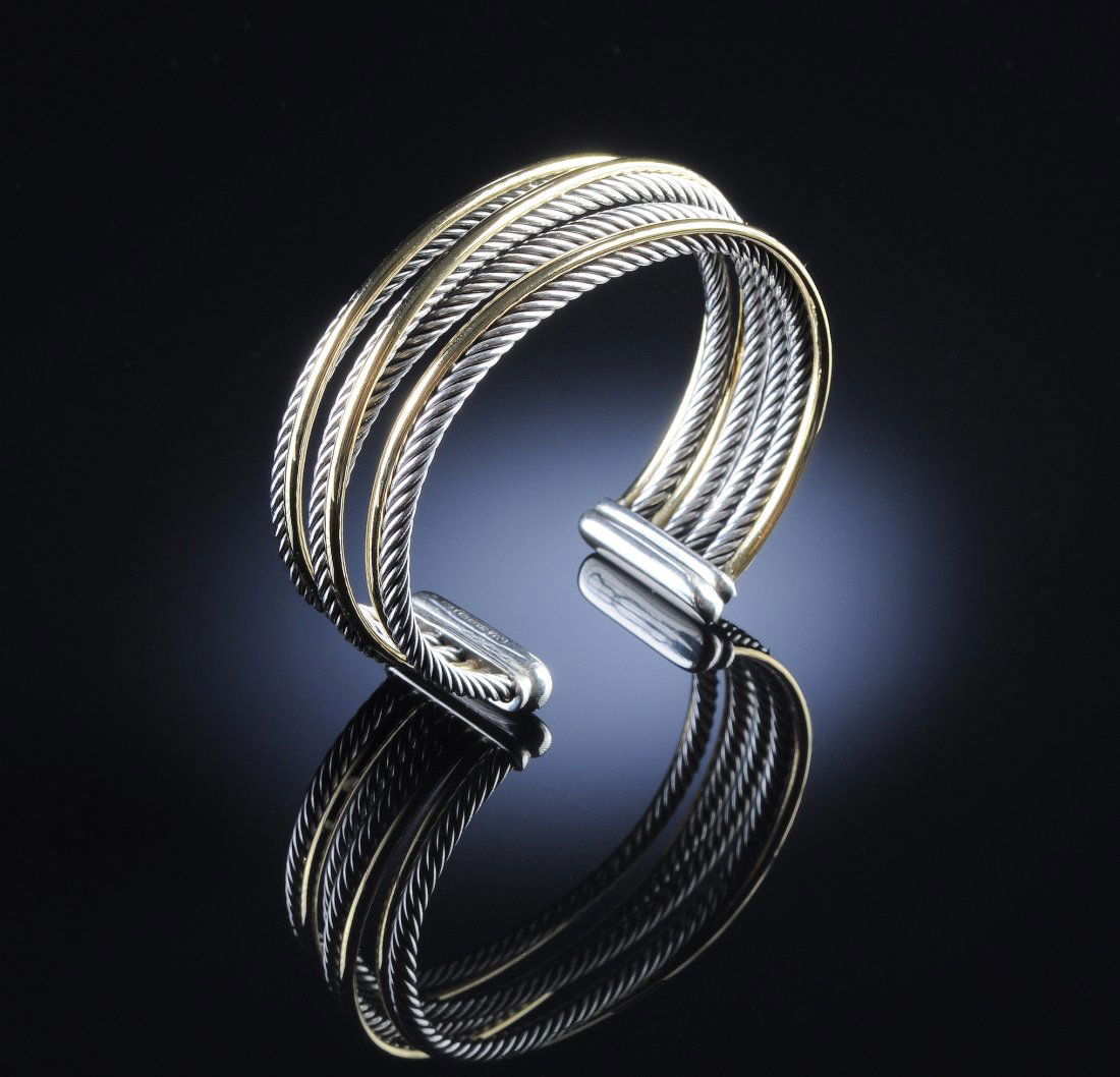 AN 18K/STERLING DAVID YURMAN CROSSOVER LADY'S BRA: AN 18K/STERLING DAVID YURMAN CROSSOVER LADY'S BRACELET, cuff style with four 2.5 millimeter sterling cables and three 1.5 millimeter bright polish yellow gold sections. Signed. Weight 51.5 grams.