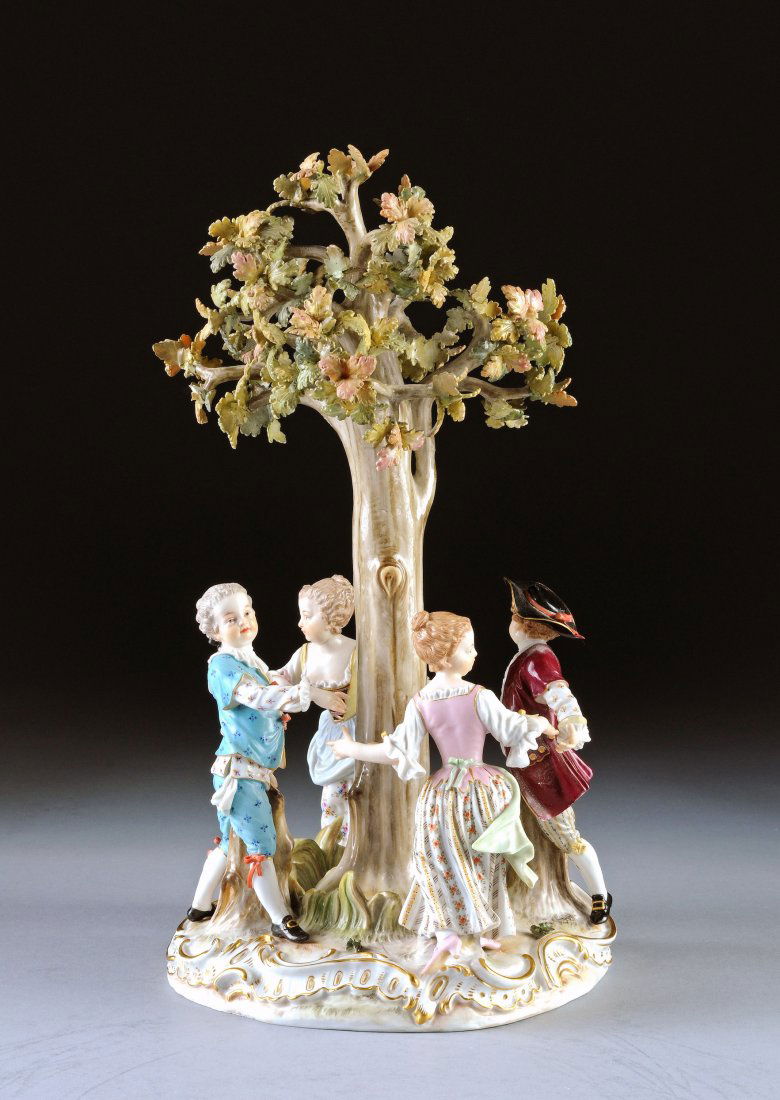 A MEISSEN POLYCHROME PAINTED FIGURAL GROUP OF CHI: A MEISSEN POLYCHROME PAINTED FIGURAL GROUP OF CHILDREN DANCING AROUND A TREE, UNDERGLAZE BLUE CROSSED SWORDS MARK, INCISED 2768., LATE 19TH/EARLY 20TH CENTURY, nicely modeled and detailed with boys an