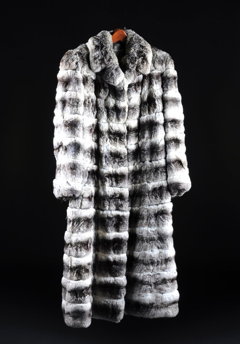 A LADY'S CHINCHILLA ADJUSTABLE LENGTH COAT, NEIMA: A LADY'S CHINCHILLA ADJUSTABLE LENGTH COAT, NEIMAN MARCUS, SIZE 6, with straight sleeves, two hook and eye clasps, collar, monogram to interior. The coat can be adjusted from tea length to full length