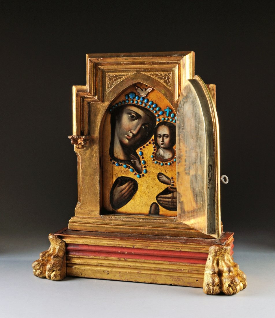 AN ITALIAN TABERNACLE OF MADONNA AND CHILD, LATE: AN ITALIAN TABERNACLE OF MADONNA AND CHILD, LATE 19TH/EARLY 20TH CENTURY, tempera, gold leaf and semiprecious jewels on board behind an arched door, all contained in a massive ornate carved giltwood s