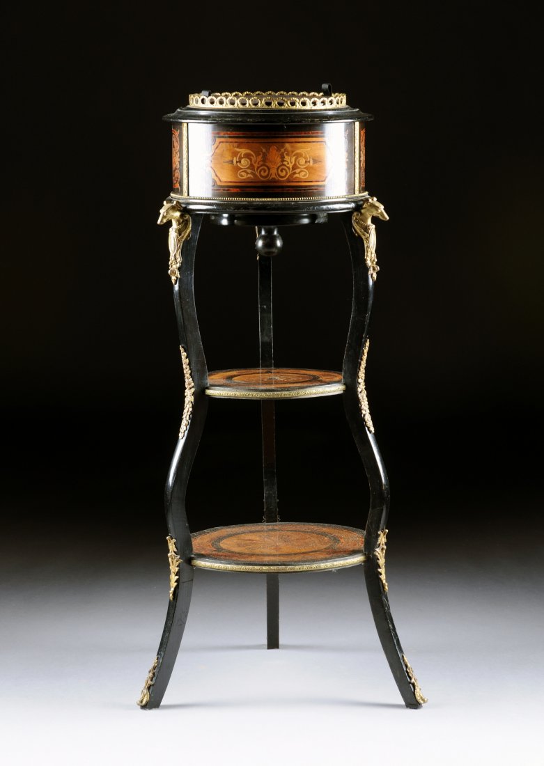 A VICTORIAN GILT BRASS MOUNTED EBONIZED AND EXOTI: A VICTORIAN GILT BRASS MOUNTED EBONIZED AND EXOTIC WOOD INLAID PEDESTAL JARDINIÈRE, 1880'S, the pierced circular galleried top enclosing a removable lid revealing a tole planter above sides centering