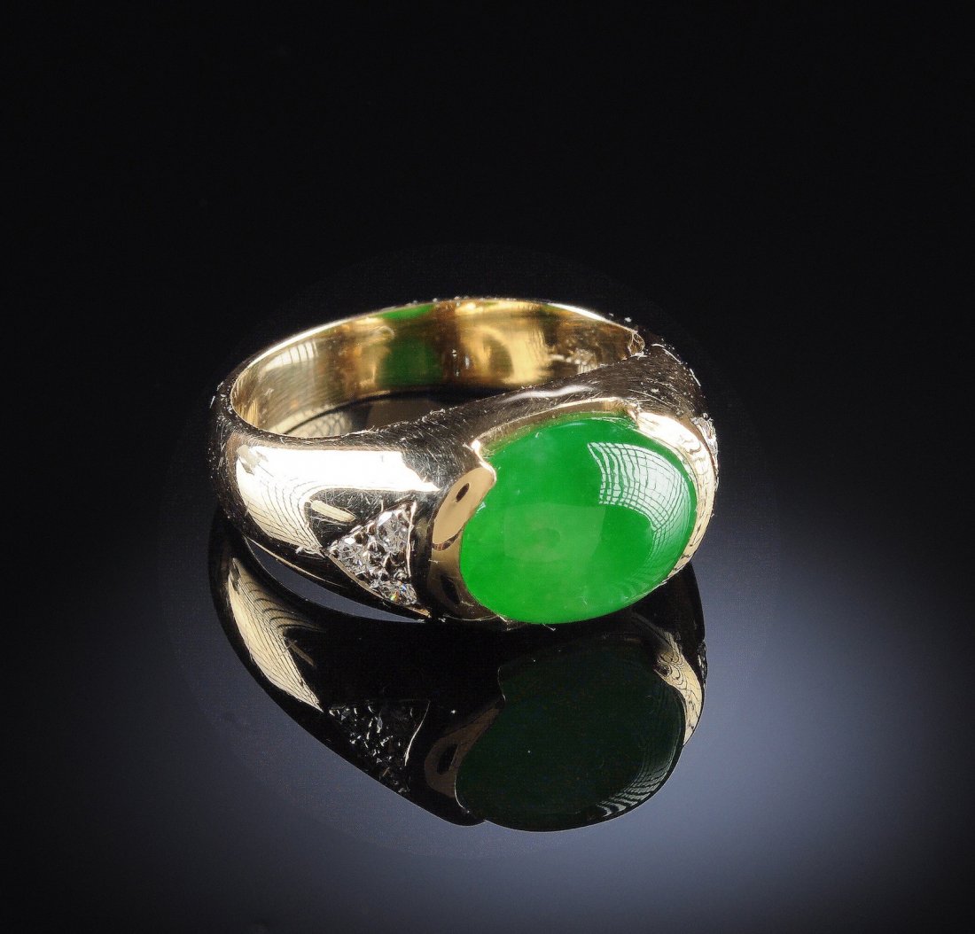 A 14K CHINESE "A" JADEITE JADE DIAMOND LADY'S RIN: A 14K CHINESE "A" JADEITE JADE DIAMOND LADY'S RING, in yellow gold centering a natural, type "A" jadeite jade oval cabochon measuring approximately 11 x 8.5 x 5 millimeters, a medium green color, very