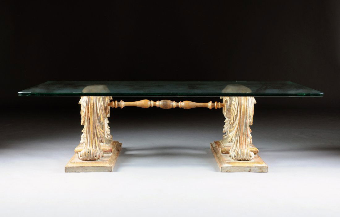 A MODERN PARCEL GILT CARVED WOOD AND GLASS TOP OC: A MODERN PARCEL GILT CARVED WOOD AND GLASS TOP OCCASIONAL TABLE, LATE 20TH CENTURY, the rounded rectangular glass top on a base of scrolling acanthus connected by turned supports. Height: 15 3/4" Widt