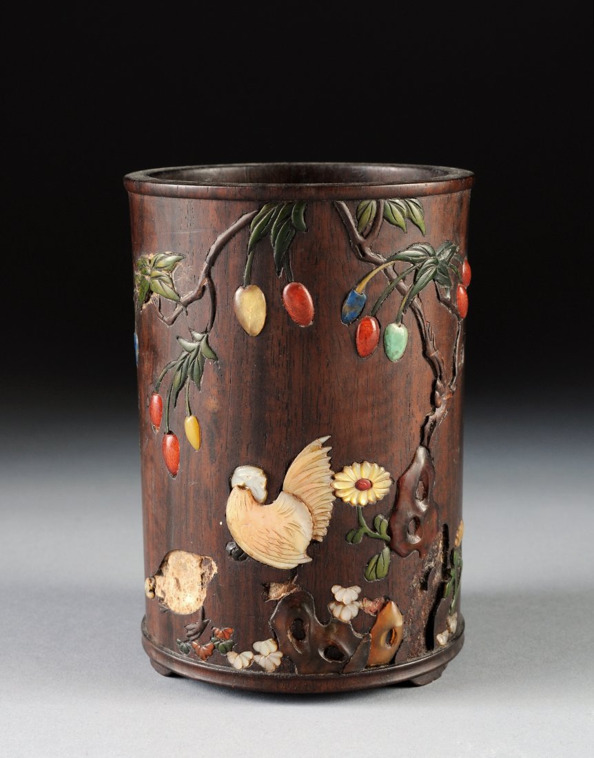 A CHINESE CARVED HARDWOOD GEMSTONE INLAID BRUSHPO: A CHINESE CARVED HARDWOOD GEMSTONE INLAID BRUSHPOT, QING DYNASTY (1644-1911), the cylindrical vessel featuring a scene inlaid with mother of pearl, amber, turquoise, lapis, carnelian, and nephrite, de