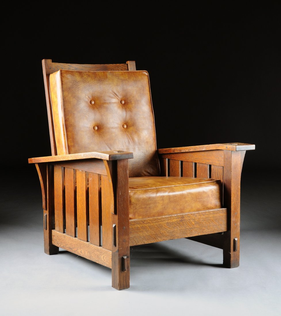 A GUSTAV STICKLEY ADJUSTABLE OAK ARMCHAIR, RED JO: A GUSTAV STICKLEY ADJUSTABLE OAK ARMCHAIR, RED JOINERS COMPASS MARK, 1904-1912, the curved rectangular peg hinged back rest with four adjustable levels and enclosing five horizontal splats flanked by 