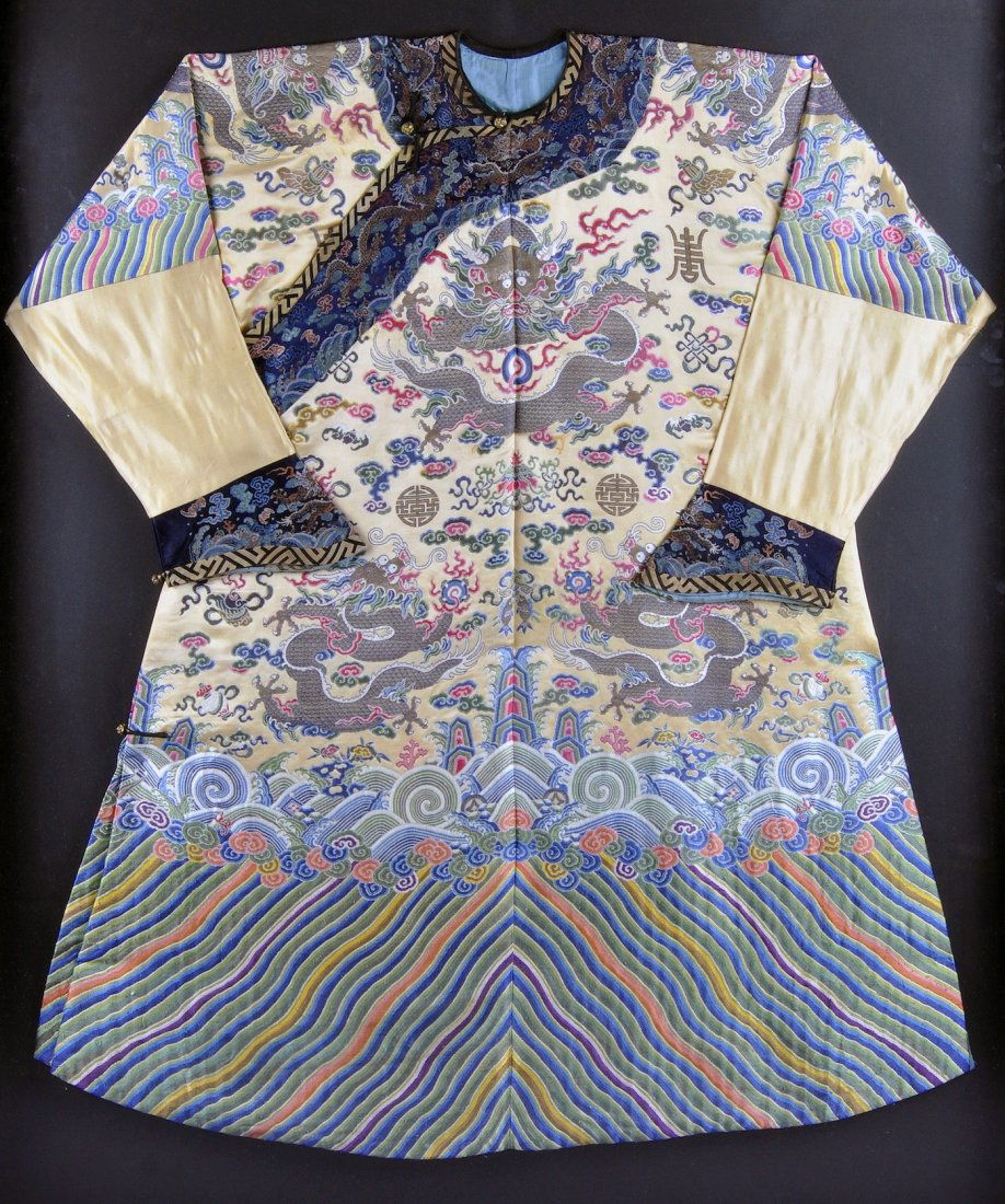 A RARE CHINESE IMPERIAL POLYCHROME THREAD EMBROID: A RARE CHINESE IMPERIAL POLYCHROME THREAD EMBROIDERED YELLOW GROUND SILK DRAGON ROBE, JIFU, LATE QING DYNASTY, CIRCA 1900, worked in a counted stitch and gold threads with four claw dragons chasing th