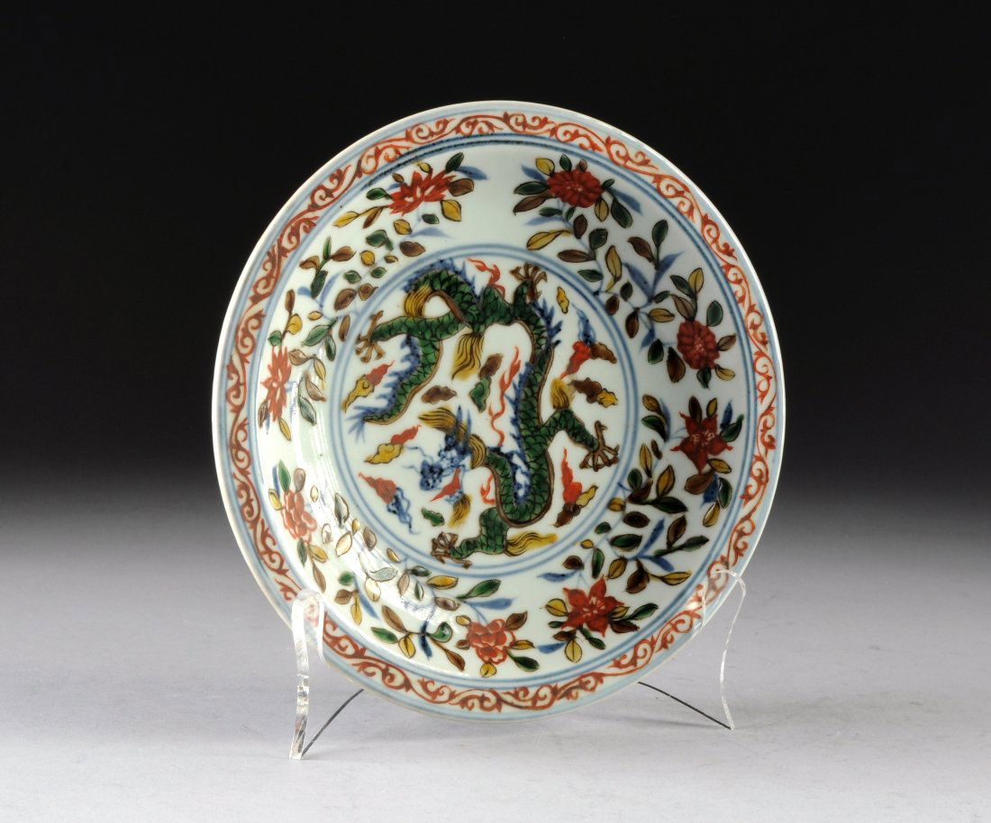 A CHINESE DOU CAI SHALLOW FOOTED PLATE, REPUBLIC PERIOD: A CHINESE DOU CAI SHALLOW FOOTED PLATE, REPUBLIC PERIOD, EARLY 20TH CENTURY, having a celadon ground with blue underglaze, green, yellow and brown over glaze in the form of foliate stems with red iron