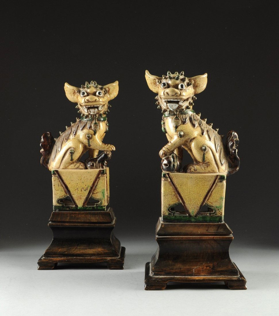 A PAIR OF CHINESE CERAMIC IMPERIAL LIONS, 19TH/20TH: A PAIR OF CHINESE CERAMIC IMPERIAL LIONS, 19TH/20TH CENTURY, the polychrome decorated lions with crazing throughout, featuring wide swept ears, wide eyes, and open mouths, resting on ceramic plinth ba
