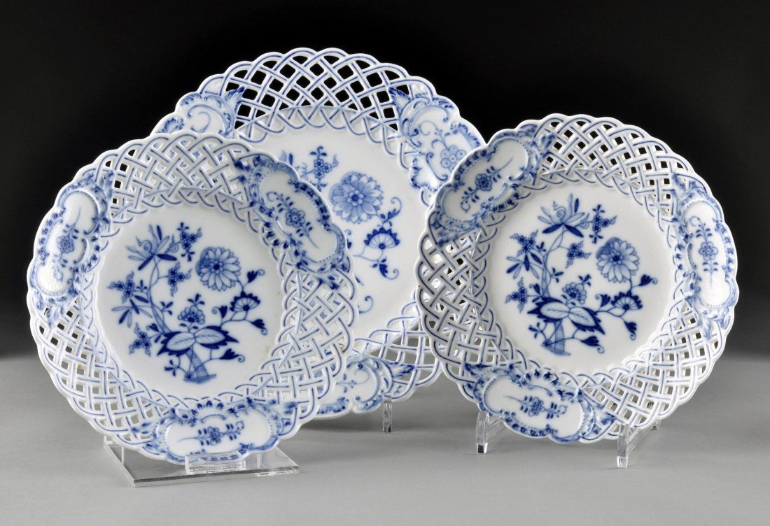 A GROUP OF THREE GERMAN BLUE ONION RETICULATED PLATES, : A GROUP OF THREE GERMAN BLUE ONION RETICULATED PLATES, MEISSEN, BLUE CROSSED SWORDS, Pressenummers 2, 24, 28, 54, Ernst Teichert, blue mark above Meissen, 1850-1924, comprising; two Meissen basket wea