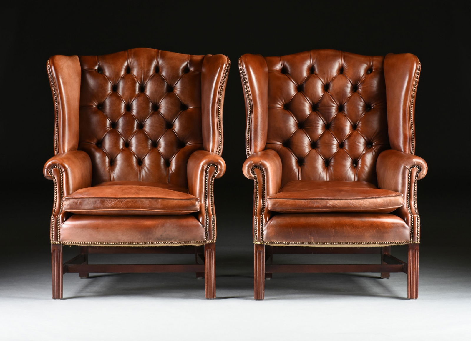 A PAIR OF LEATHER ARMCHAIRS, 20TH CENTURY, (1 of 6)