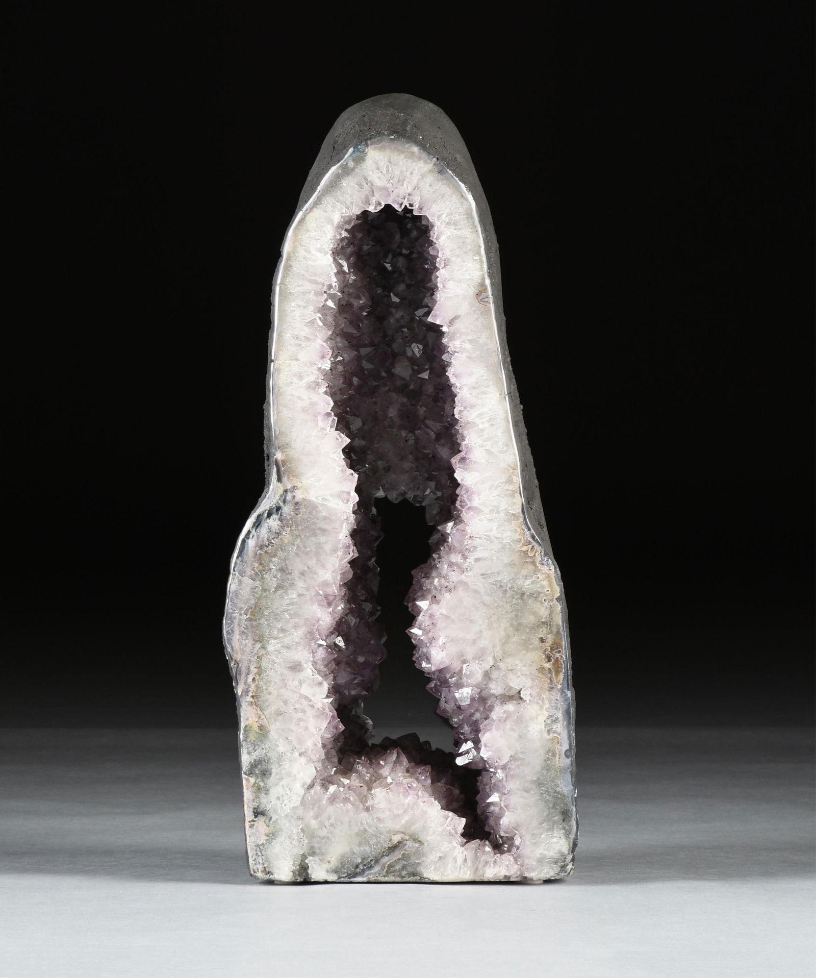AN AMETHYST CATHEDRAL WINDOW GEODE SPECIMEN, BRAZIL,: AN AMETHYST CATHEDRAL WINDOW GEODE SPECIMEN, BRAZIL,a polished natural amethyst geode. Total approximate weight: 94 lbs.27.5 x 11.5 x 6.5 Provenance: Collection of Fossils and Gemstones of Houston, Te