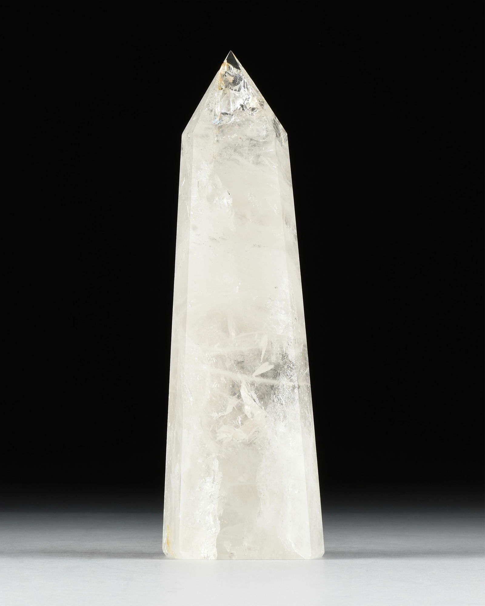 A QUARTZ CRYSTAL OBELISK, BRAZIL,: A QUARTZ CRYSTAL OBELISK, BRAZIL,cut and polished quartz in the form of an obelisk. Total approximate weight: 12.5 lbs.16 x 5 x 2.75 Provenance: Collection of Fossils and Gemstones of Houston, Texas.