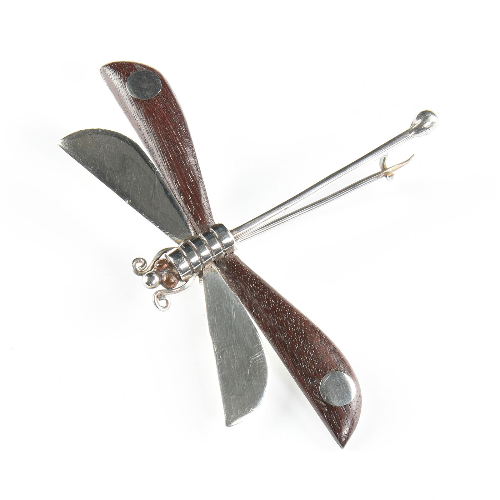 WILLIAM SPRATLING (American 1900-1967) A TAXCO STERLING SILVER AND EBONY DRAGONFLY BROOCH, CIRCA: WILLIAM SPRATLING (American 1900-1967) A TAXCO STERLING SILVER AND EBONY DRAGONFLY BROOCH, CIRCA 1960,a sterling silver and wood brooch, marked "William Spratling Taxco Mexico in a circle around the a