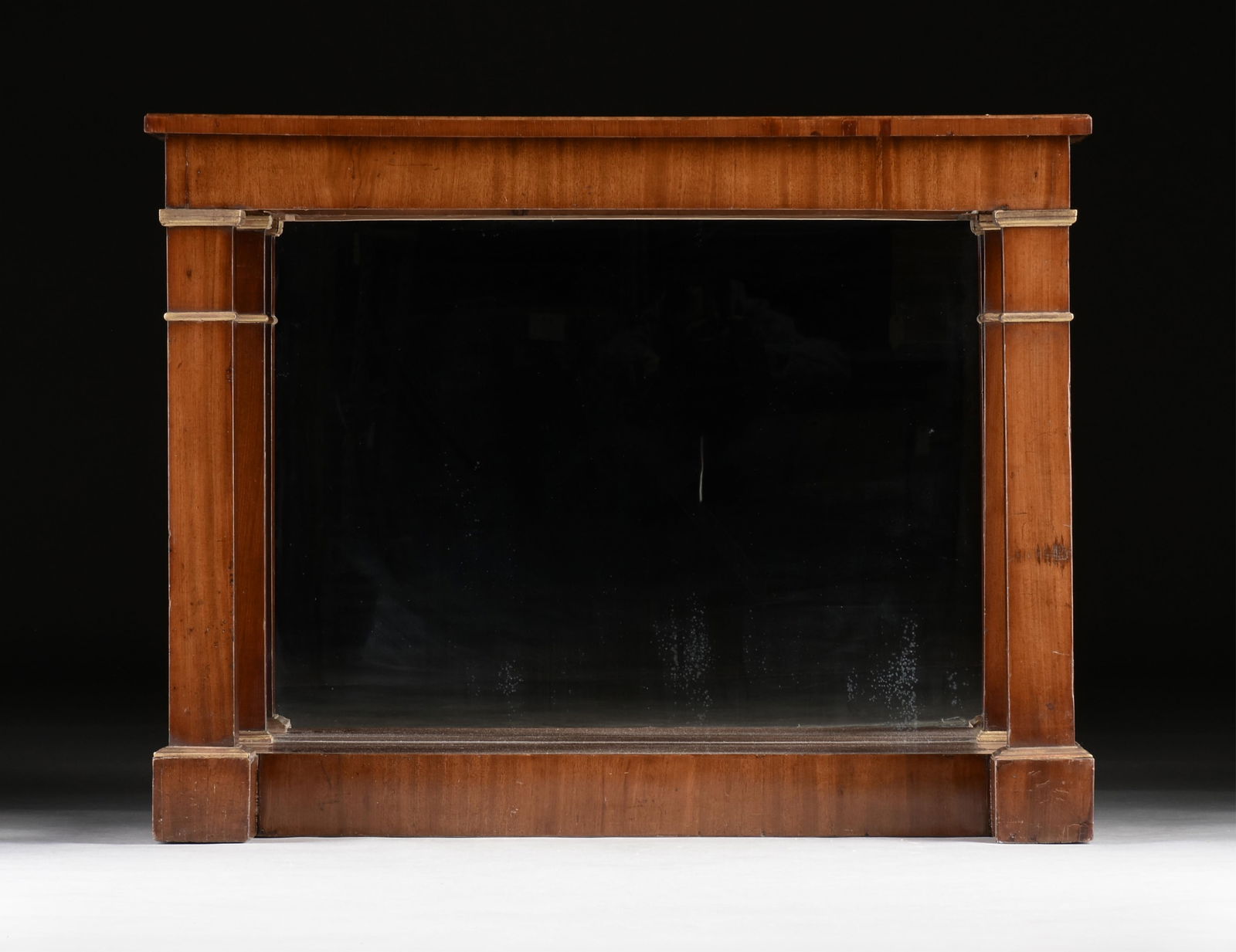A NEOCLASSICAL STYLE MAHOGANY CONSOLE TABLE, 19TH CENTURY,: A NEOCLASSICAL STYLE MAHOGANY CONSOLE TABLE, 19TH CENTURY,a wooden console table with mahogany veneer and a mirrored back.35 1/2 x 46 x 19 1/2 in. (90.2 x 116.8 x 49.5 cm.) Provenance: Private Collect