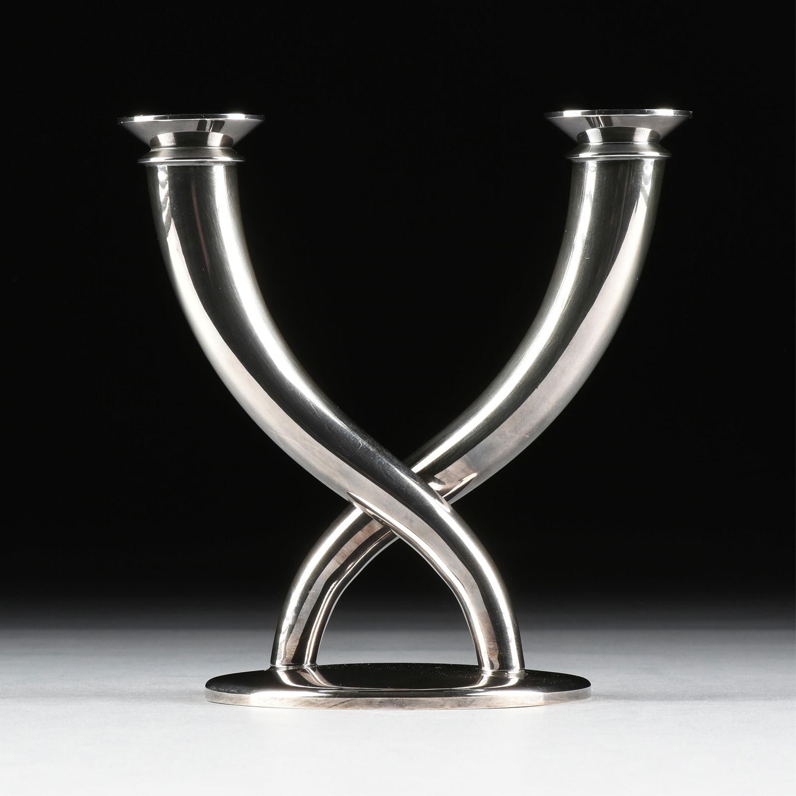 GIO PONTI (Italian 1891-1979) A CHRISTOFLE "Gallia" CANDELABRUM, FRENCH, 20TH CENTURY,: GIO PONTI (Italian 1891-1979) A CHRISTOFLE "Gallia" CANDELABRUM, FRENCH, 20TH CENTURY,a silver-plated two-light candelabrum, marked on lower edge of base, "CHRISTOFLE FRANCE."8 1/8 x 8 x 5 3/8 in. (20