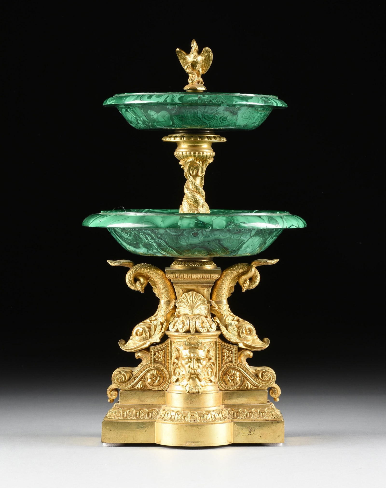 A BRONZE ORMOLU AND MALACHITE TIERED CENTERPIECE, FRENCH, 19TH/20TH CENTURY,: A BRONZE ORMOLU AND MALACHITE TIERED CENTERPIECE, FRENCH, 19TH/20TH CENTURY,an elaborate centerpiece with a bronze ormolu base and center post supporting two malachite bowls.19 x 10 1/2 x 10 1/2 in. (