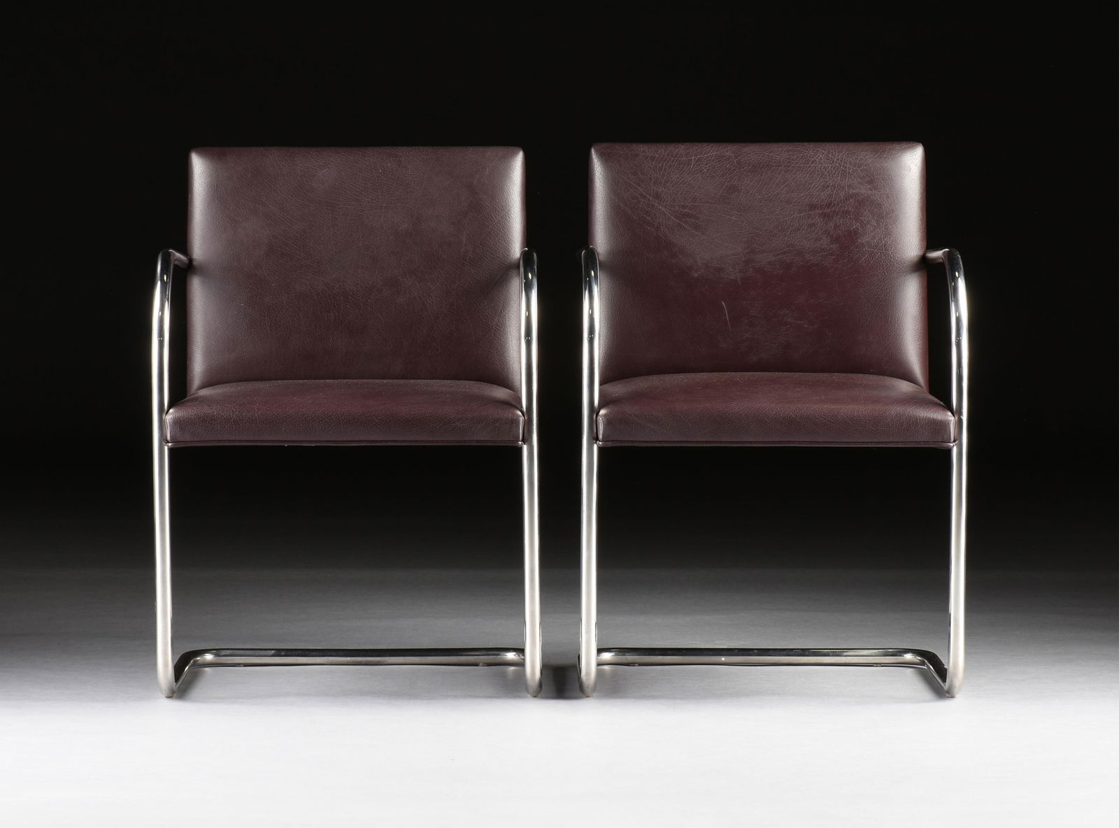 MIES VAN DER ROHE (German/American 1886-1969) FOUR KNOLL BRNO TUBULAR SIDE CHAIRS, AMERICAN,: MIES VAN DER ROHE (German/American 1886-1969) FOUR KNOLL BRNO TUBULAR SIDE CHAIRS, AMERICAN,four tubular steel chairs with dark maroon leather upholstery, each marked on underside of armrest, "Knoll S