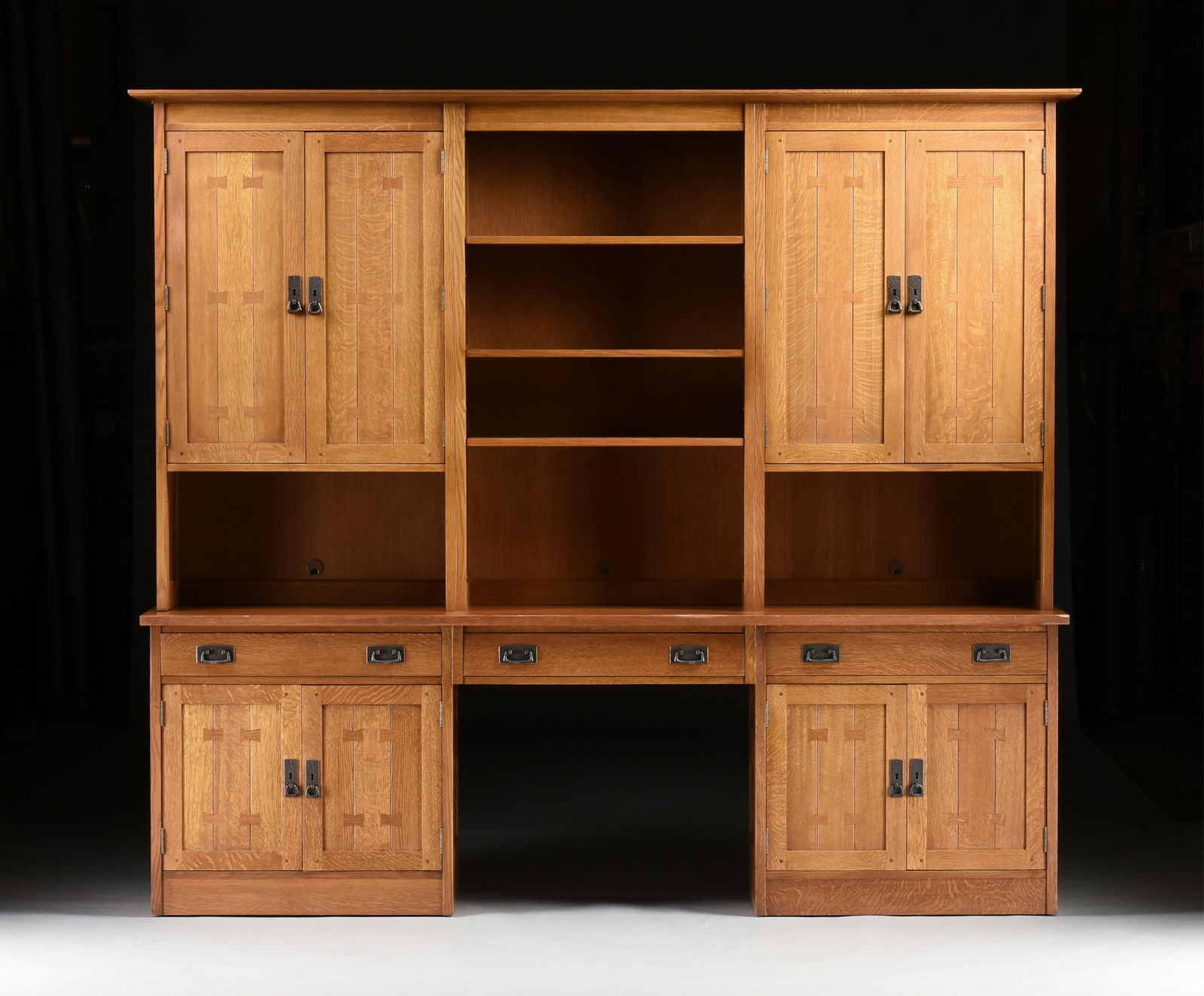A STICKLEY MISSION STYLE HUTCH DESK, AMERICAN, 21ST CENTURY,: A STICKLEY MISSION STYLE HUTCH DESK, AMERICAN, 21ST CENTURY,a three drawer oak wall desk with a central knee hole flanked by two lower cabinets, and a hutch with adjustable shelves flanked by two cabi