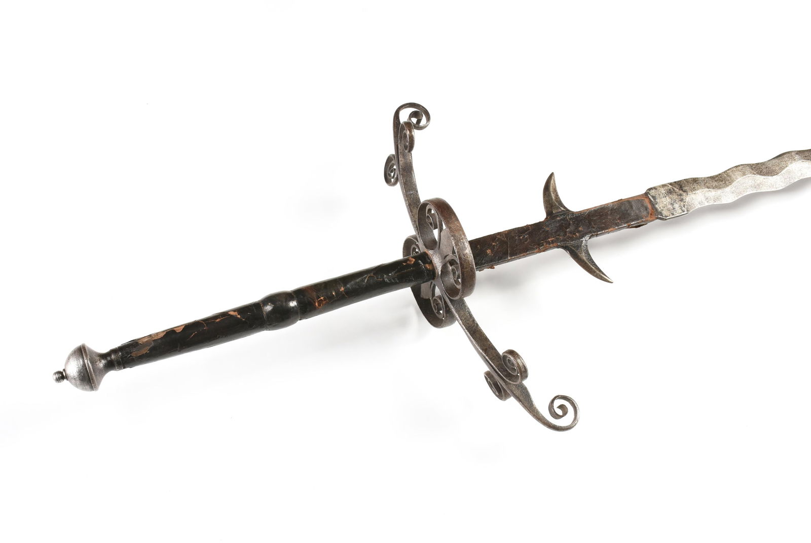 A TWO-HANDED FLAME-BLADED SWORD, GERMAN, 16TH CENTURY,: A TWO-HANDED FLAME-BLADED SWORD, GERMAN, 16TH CENTURY,a double edged waved-blade with a long ricasso with parrying hooks, a guard with scroll work and fleur-de-lys side rings, and a wooden and leather