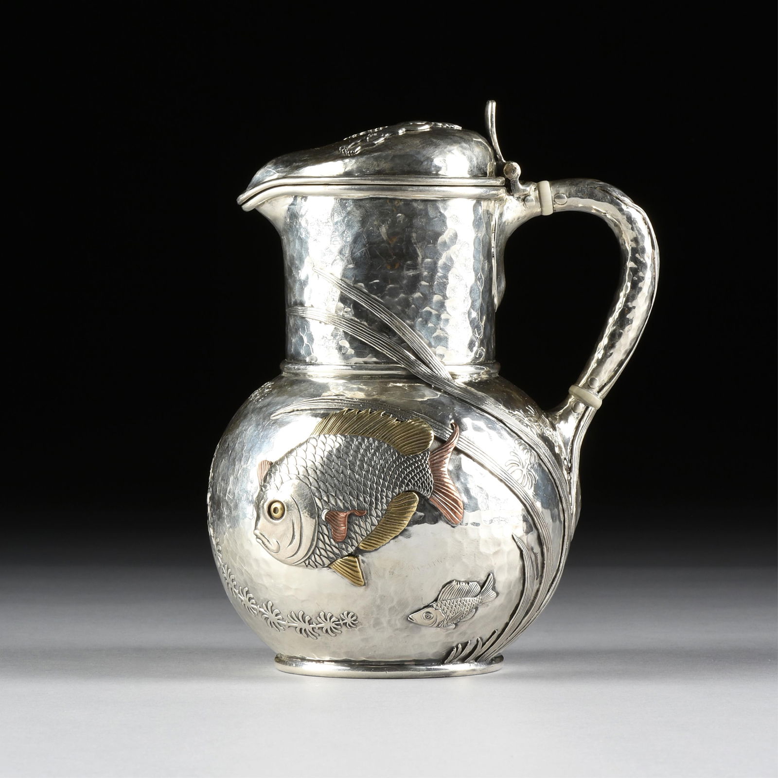 A TIFFANY & CO. STERLING SILVER AND MIXED METAL PITCHER, AMERICAN, LATE 19TH CENTURY, (1 of 12)