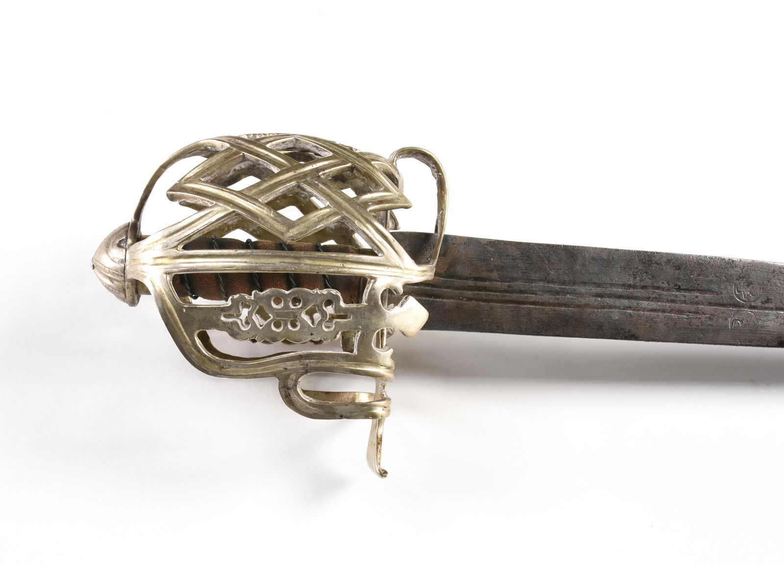 A SILVER BASKET HILTED BROADSWORD WITH DIAMOND MOTIF, SCOTTISH, 1ST HALF 18TH CENTURY,: A SILVER BASKET HILTED BROADSWORD WITH DIAMOND MOTIF, SCOTTISH, 1ST HALF 18TH CENTURY,a double edged blade with a small central fuller, a coin silver basket hilt ornamented with geometric designs, wit