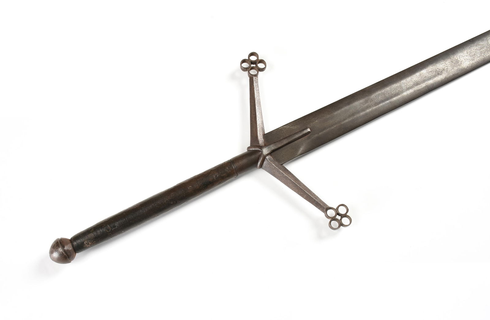 A TWO-HANDED HIGHLAND SWORD, SCOTTISH, 15TH/16TH CENTURY,: A TWO-HANDED HIGHLAND SWORD, SCOTTISH, 15TH/16TH CENTURY,a double edged blade with quillons inclined towards the blade ending in quatrefoil forms, and a leather wrapped iron hilt with rounded pommel.5