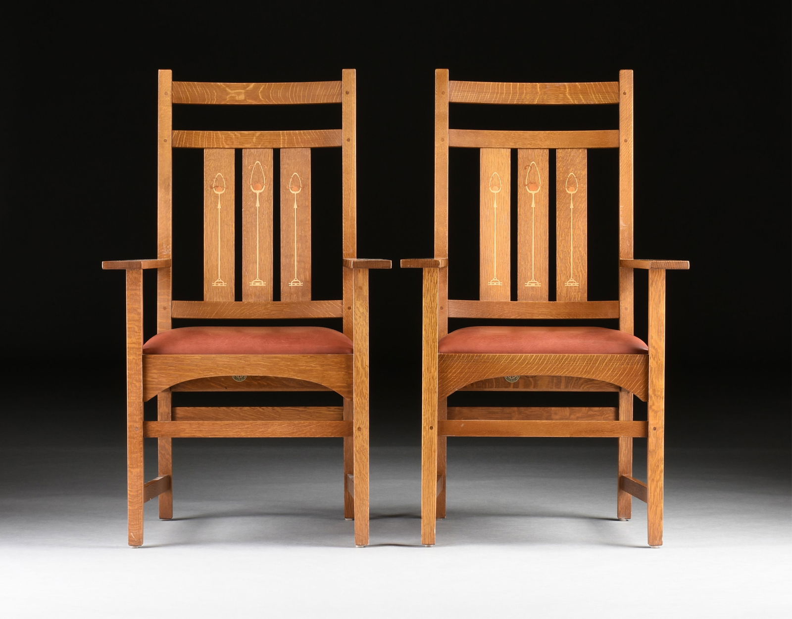 A PAIR OF STICKLEY "Harvey Ellis" ARMCHAIRS, AMERICAN, 21ST CENTURY,: A PAIR OF STICKLEY "Harvey Ellis" ARMCHAIRS, AMERICAN, 21ST CENTURY,two wooden chairs with decorative inlay and red leather seats, marked on stretcher.Each: 43 1/2 x 26 x 22 in. (110.5 x 66 x 55.9 cm.