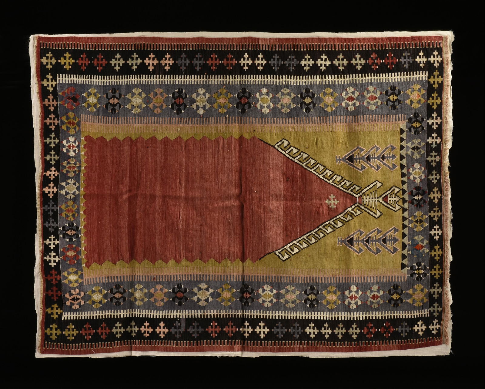 A MILAS MIHRAB PRAYER RUG, TURKEY, LATE 19TH/EARLY 20TH CENTURY,: A MILAS MIHRAB PRAYER RUG, TURKEY, LATE 19TH/EARLY 20TH CENTURY,naturally dyed wool, with a central niche of red ground on a pistachio green ground within patterned borders of blue, black, and red.76