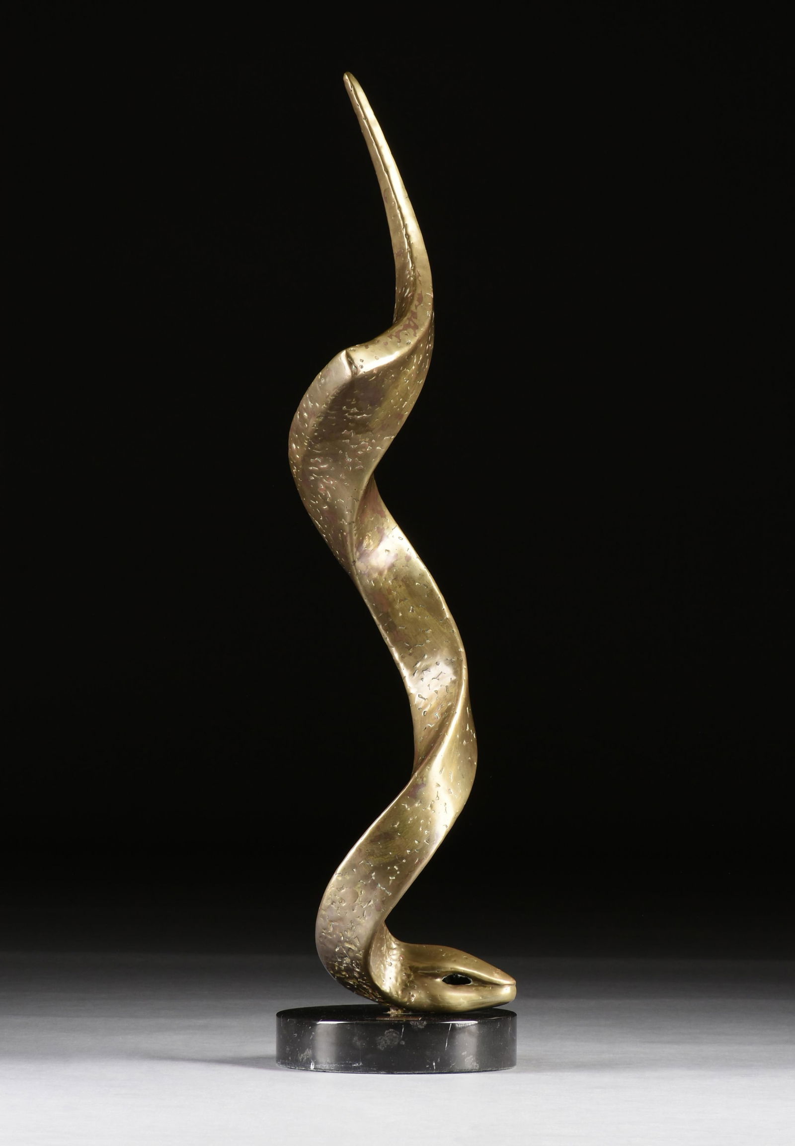 VICTOR MANUEL CONTRERAS (Mexican 1941-2023) "Quetzalcoatl," 1978,: VICTOR MANUEL CONTRERAS (Mexican 1941-2023) "Quetzalcoatl," 1978,bronze sculpture on a black marble base.46 x 11 x 11 in. (116.8 x 27.9 x 27.9 cm.) Provenance: Private Collection, Houston, Texas.