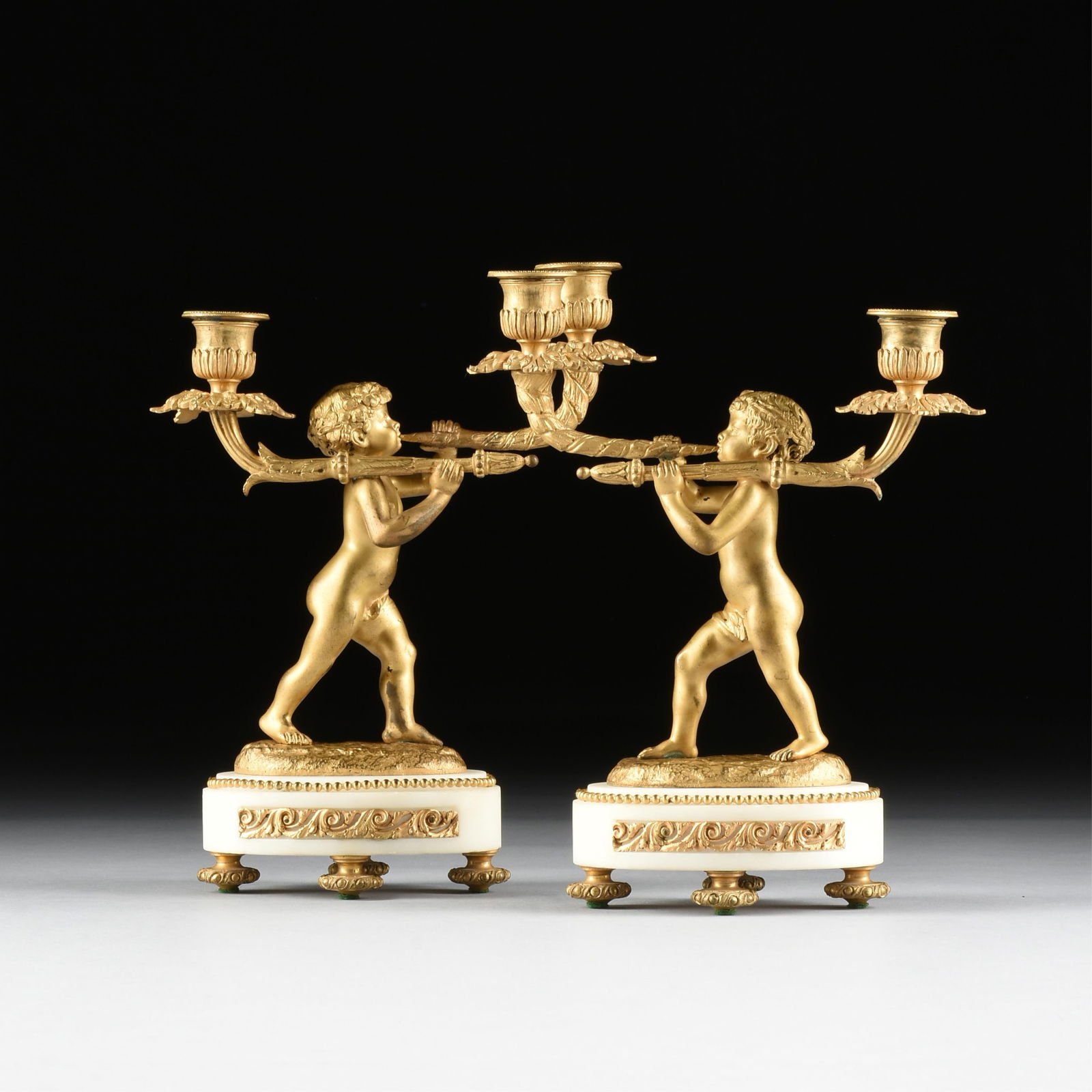 A PAIR OF NEOCLASSICAL STYLE BRONZE ORMOLU TWO-LIGHT PUTTI CANDELABRA, FRENCH, 19TH CENTURY, (1 of 9)