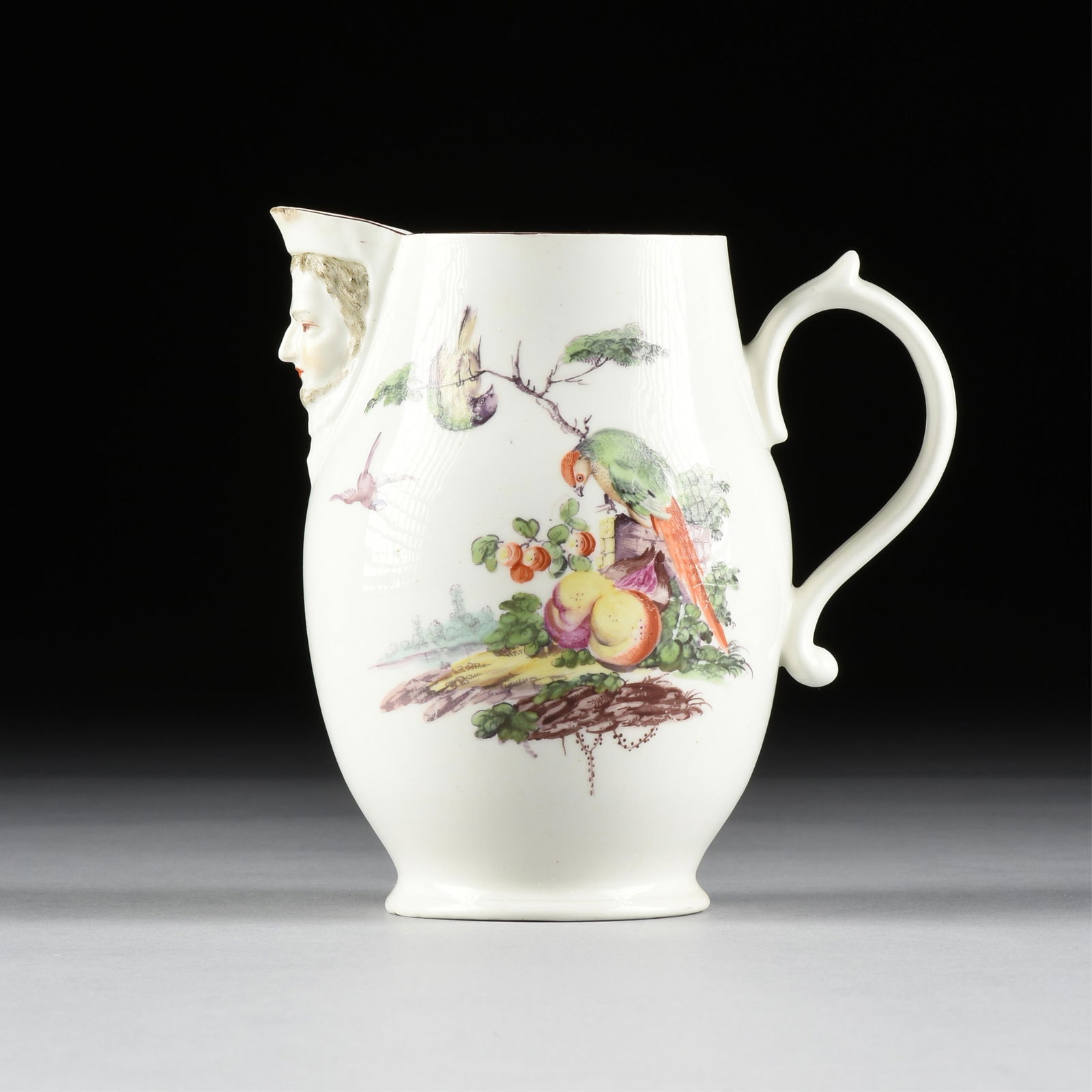 A WILLIAM DUESBURY & CO. PORCELAIN MASK JUG, ENGLISH, CIRCA 1760s,: A WILLIAM DUESBURY & CO. PORCELAIN MASK JUG, ENGLISH, CIRCA 1760s,hand painted porcelain.6 1/2 x 6 1/4 x 5 in. (16.5 x 15.9 x 12.7 cm.) Provenance: Collection of the Norbert Choucroun Trust, Houston,