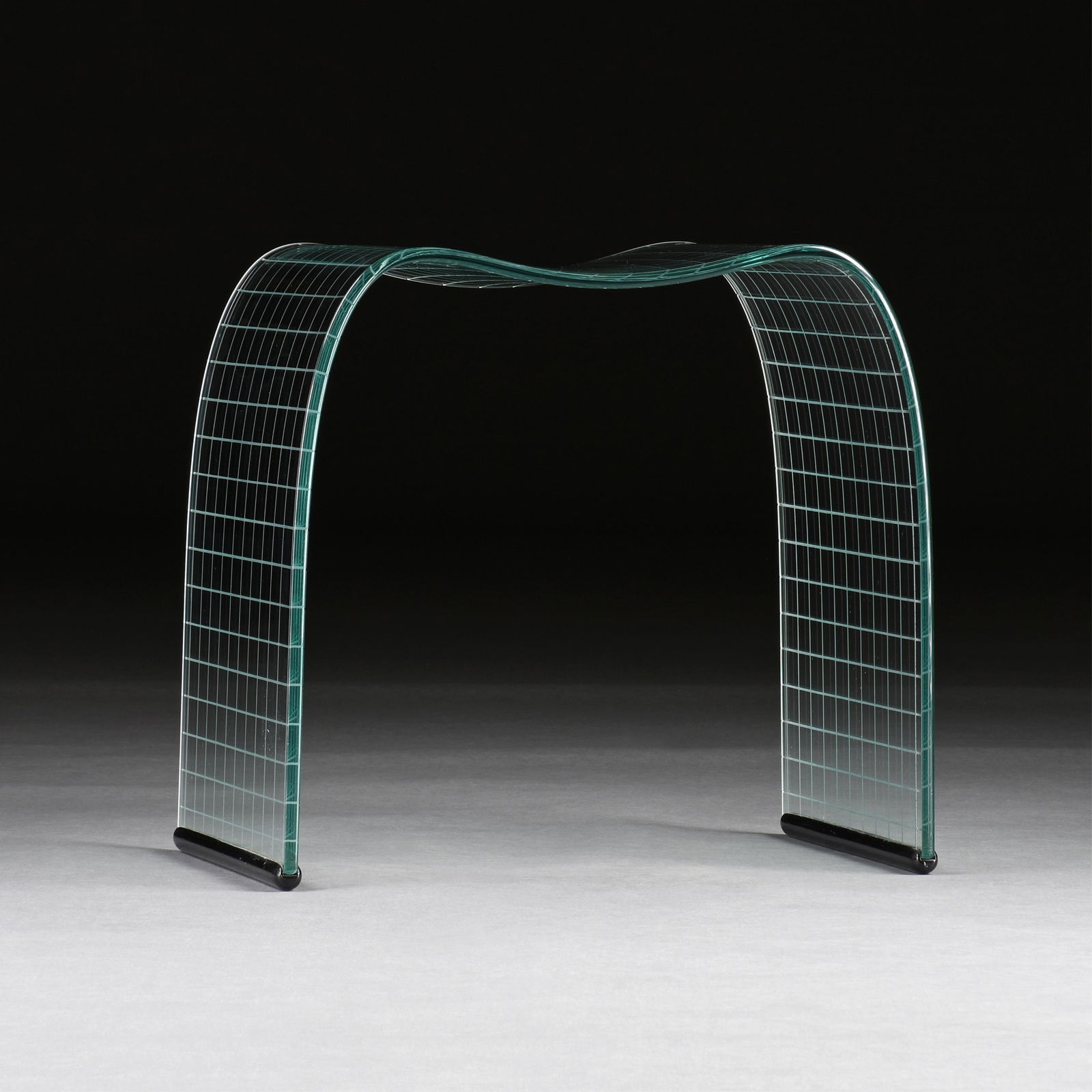 VITTORIO LIVI (Italian b. 1944) A FIAM "Onda Incisa" STOOL, ITALIAN, 20TH CENTURY,: VITTORIO LIVI (Italian b. 1944) A FIAM "Onda Incisa" STOOL, ITALIAN, 20TH CENTURY,a curved and etched glass stool.20 3/4 x 22 3/4 x 13 3/4 in. (52.7 x 57.8 x 34.9 cm.)