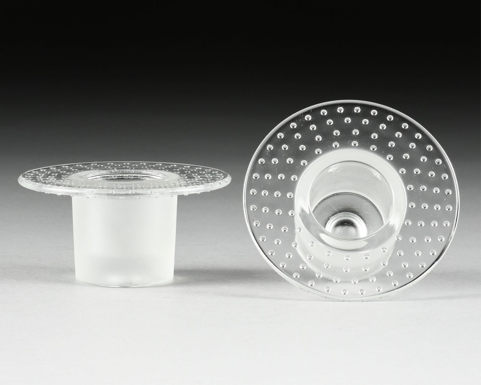 A PAIR OF NUUTAJARVI VOTIVE CANDLE HOLDERS, FINNISH, LATE 20TH CENTURY,: A PAIR OF NUUTAJARVI VOTIVE CANDLE HOLDERS, FINNISH, LATE 20TH CENTURY,clear and frosted glass.Each: 2 3/8 in. (6 cm.)