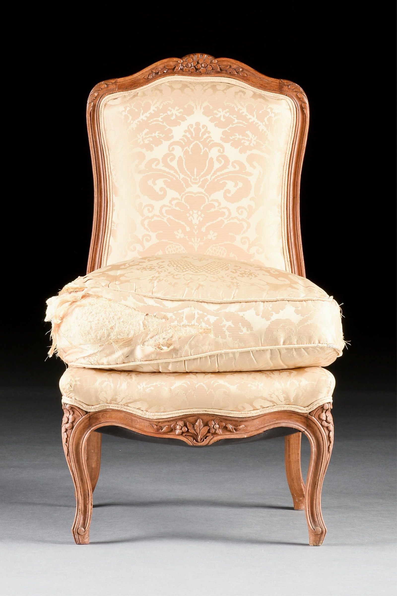 A ROCOCO STYLE SLIPPER CHAIR, FRENCH, 19TH CENTURY,: A ROCOCO STYLE SLIPPER CHAIR, FRENCH, 19TH CENTURY,a petite chair with carved wooden frame and silk upholstery.33 1/2 x 20 x 20 in. (85.1 x 50.8 x 50.8 cm.) Provenance: Collection of the Norbert Chouc
