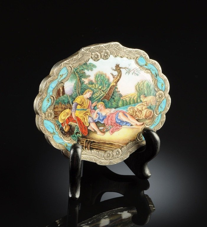 AN ITALIAN COLORFULLY ENAMELED AND ENGRAVED SILVER LADY: AN ITALIAN COLORFULLY ENAMELED AND ENGRAVED SILVER LADY'S POWDER CASE, BY TERONA GIOVANNI, FLORENCE (ACTIVE 1935-1949), of shaped oval form with a hinged lid centering a shepherd youth and maiden shep