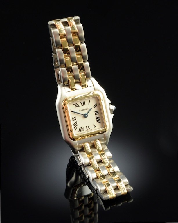 AN 18K YELLOW GOLD AND STAINLESS CARTIER PANTHER LADY'S: AN 18K YELLOW GOLD AND STAINLESS CARTIER PANTHER LADY'S WATCH, with quartz movement and an off white dial, triple signed 'Cartier', with two tone bracelet, fold over hidden deployant clasp. Operationa