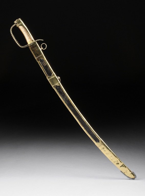 FRENCH SWORD, CIRCA 1780, curved blade with polished b: FRENCH SWORD, CIRCA 1780, curved blade with polished brass guard, alternating copper and brass wired grip, complete with a leather and polished brass scabbard. Height: 39"