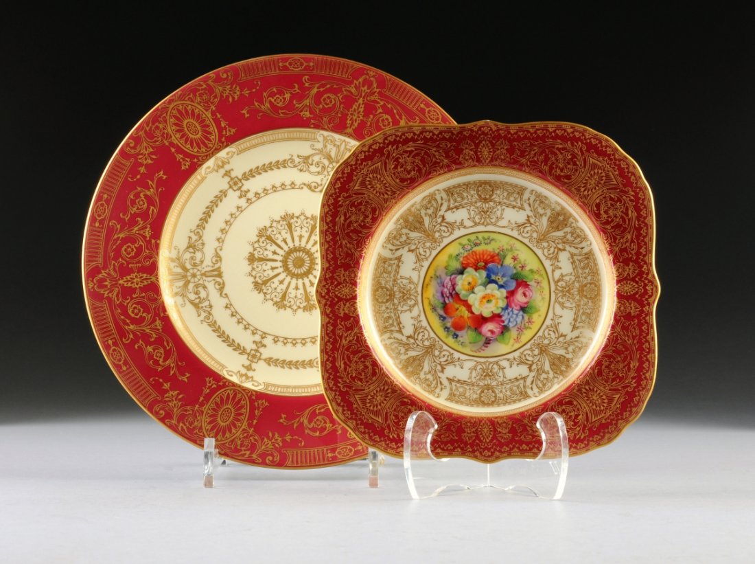 A SET OF ROYAL WORCESTER DINNER PLATES AND SALAD PLATES: A SET OF ROYAL WORCESTER DINNER PLATES AND SALAD PLATES, ENGLAND, CIRCA 1926-28, comprising a set of 14 dinner plates with ruby border with gilt medallions and scroll work, having a cream center with 
