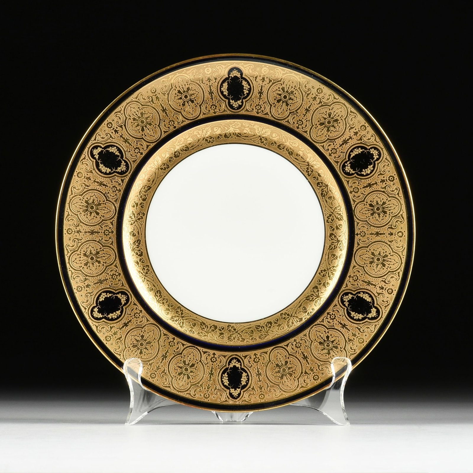 TWELVE LANTERNIER & CO. LIMOGES PORCELAIN CHARGERS, FRENCH, 20TH CENTURY,: TWELVE LANTERNIER & CO. LIMOGES PORCELAIN CHARGERS, FRENCH, 20TH CENTURY, twelve gilt and dark blue porcelain chargers with stylized floral motifs, each marked on underside, "A. Lanternier & Co.