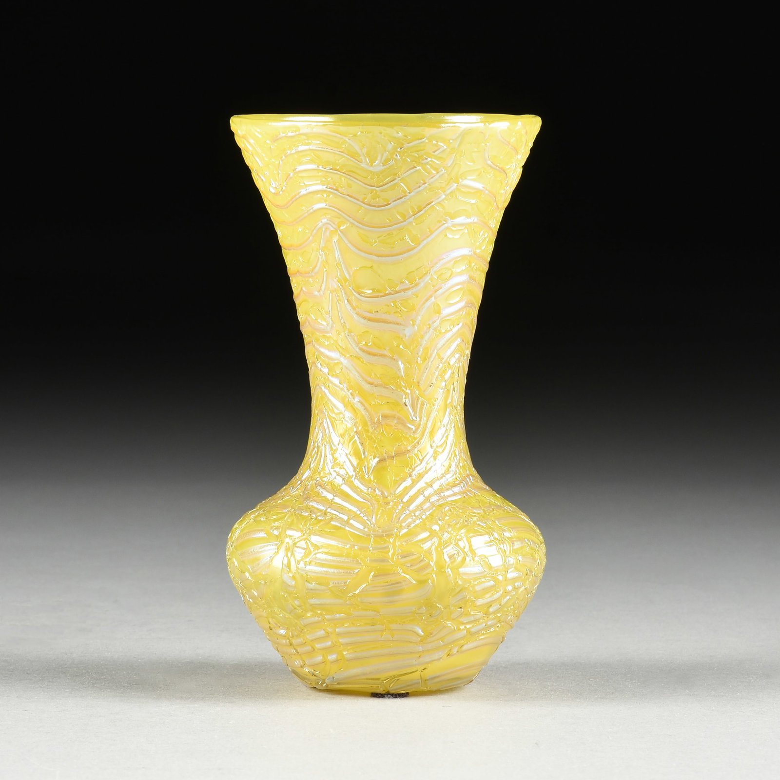 A BOHEMIAN STYLE GLASS VASE, CZECH, CIRCA 1900,: A BOHEMIAN STYLE GLASS VASE, CZECH, CIRCA 1900, hand blown opalescent and yellow crackle glass in the style of Loetz glass. 6 x 3 3/8 x 3 3/8 in. (15.2 x 8.6 x 8.6 cm.) Provenance: Private